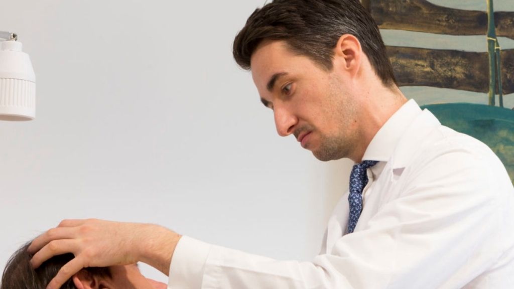 Dr. Richard Fakin conducting a follow-up consultation during the recovery process after gender affirmation surgery.